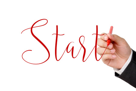 Businessman hand holding pen and start word on white background, business conceptの写真素材