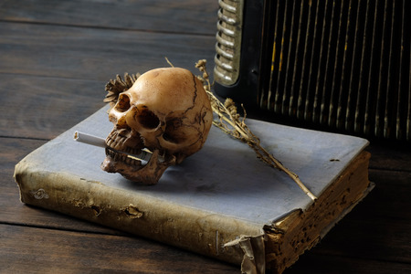 Skull and cigarette, unhealthy concept, quite smoke
