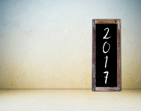 2017 on vintage chalk board over empty cement background, happy new year and christmas conceptの写真素材