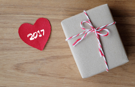 2017 on red fabric heart shape and gift box on wood background, holiday, valentines present