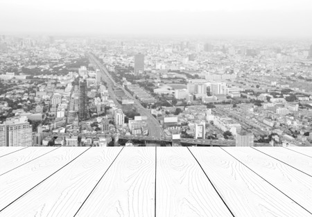 Perspective white wood over blur city scrape background, business conceptの写真素材