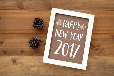 Happy new year 2017 on white vintage wooden frame background, flat lay, top viewの写真素材