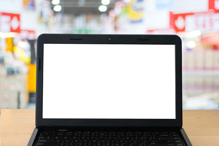 Blank screen labtop and blur supermarket background, grocery online concept, mock up, product...