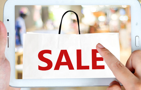 Hand holding tablet with online sale on screen, business, E-commerce, technology and digital marketingの写真素材