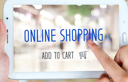 Hand holding tablet with on line shoping concept on screen, digital marketing, business technologyの写真素材