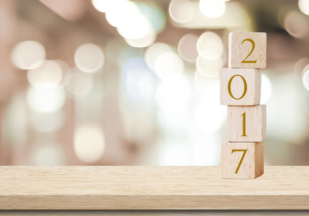 Wooden cubes with 2017 on table over blur bokeh background with copy space for text, new year templateの写真素材