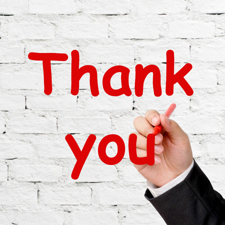 Businessman hand writing thank you sign over white background, business concept, bannerの写真素材