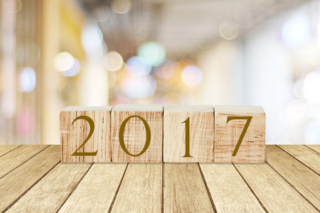 Wooden cubes with 2017 on perspective wood over blur bokeh background, new year bannerの写真素材
