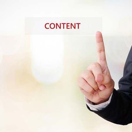 Businessman hand touch content word over blur background, digital marketing concept, businees and technologyの写真素材