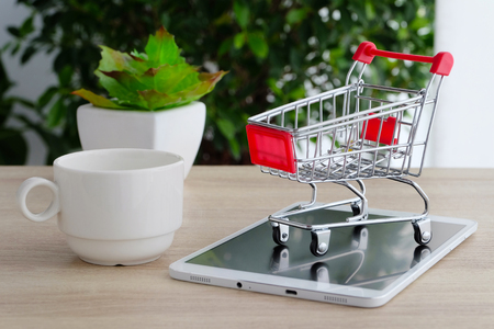 Shopping cart model on tablet, shopping online concept, business and technologyの写真素材