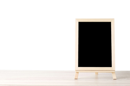 Blank chalkboard standing on wood table isolated on white background, space for text, mock up, product display montage, bannerの写真素材