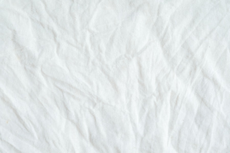Wrinkled white cotton fabric texture background, wallpaperの写真素材