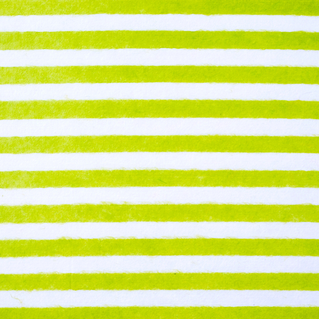 Green and white striped pattern on mulberry paper textured background, detail close-upの写真素材