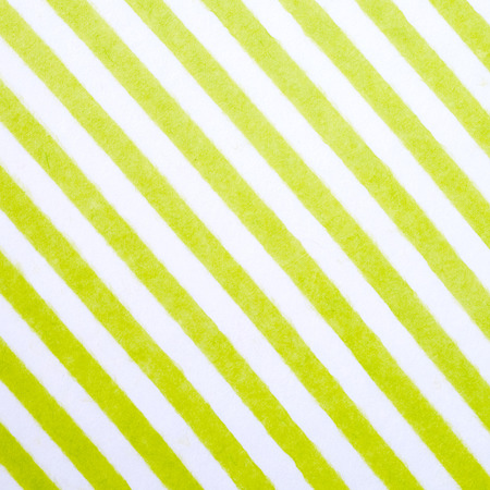 Green and white striped pattern on mulberry paper textured background, detail close-upの写真素材