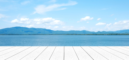 Empty perspective white wood over blue sea and blue sky background, summer holiday vacation conceptの写真素材