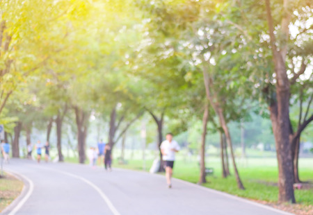Blurred background of people activities in park with bokeh, spring and summer seasonの写真素材