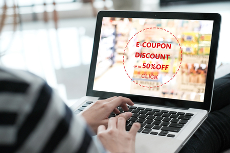 Woman entering the discount coupon code on laptop computer to get the grocery shopping on line promotion, on line shopping ,digital marketing business and technology, lifestyle concept の写真素材