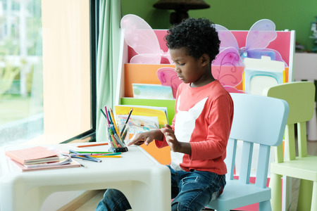 African boy in kindergarten classroom, kid education conceptの写真素材