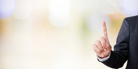 Businessman hand touching over blur office background, business background, bannerの写真素材