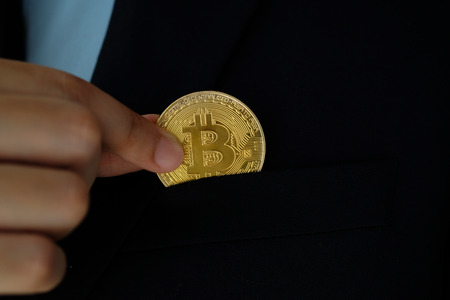 Businessman hand holding bitcoins, cryptocurrency and blockchain conceptの写真素材