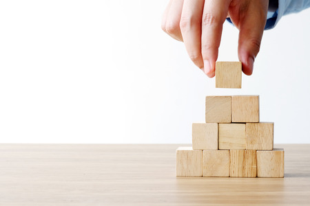 Hand holding blank wooden cubes, business concept background, mock up, templateの写真素材