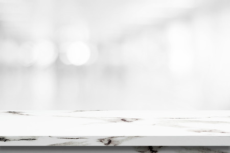 Empty white marble table over blur store background, product display montageの写真素材