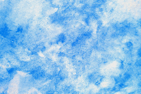 Blue abstract watercolor painting textured on white paper backgroundの写真素材
