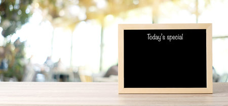 Todayâs special menu blackboard, sign board, on table at  blur coffee shop, restaurant, with people background, Blank chalkboard mock up background, food and drink background concept  の写真素材