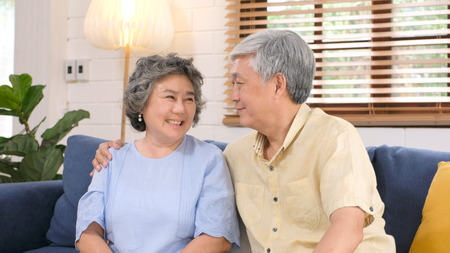 Senior asian couple in happy moment at home living room background, people emotional