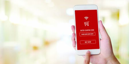 E-coupon, Shopping online, Hand using mobile phone with discount coupon on screen, online shopping...
