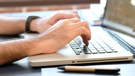 Close up of man hand typing keyboard laptop computer, work from home, study at home, people and...