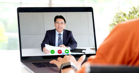 Video conference, Work from home, Businessman making video call to employee with virtual web, Contacting manager by conference on laptop computer at home, Talking on web, Online consultation  businessの写真素材