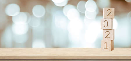 Happy New Year 2021 on wood cube block and blur abstract bokeh light background with cop space for text, Happy new year 2021 greeting card, bannerの写真素材