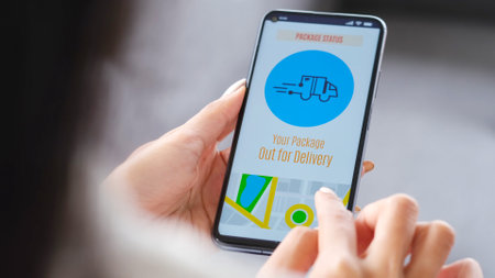 Close up of woman hands checking parcel delivers order on mobile app while sitting on the sofa at...