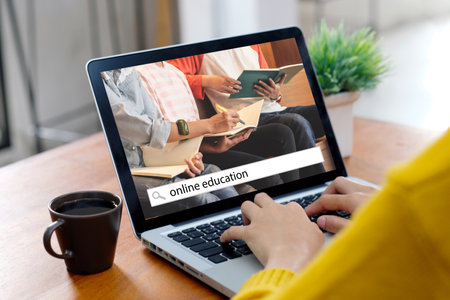 Online study class, Woman searching for online education by laptop at home backgroundの写真素材