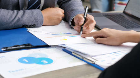 Close up of businessman hands discussing about business plan, Business team analyze business data at...