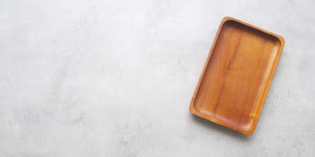 Empty wooden plate on gray cement table background, banner with copy space, Blank wood tray for food display montage, template, mock up, top view, flat layの写真素材