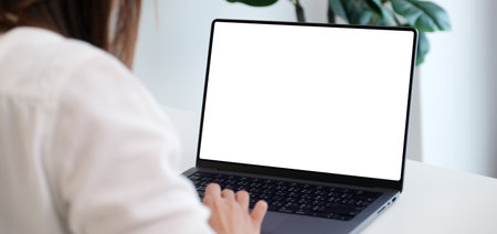 Woman using laptop computer with blank screen for mock up template background, people business technology and lifestyle background conceptの写真素材