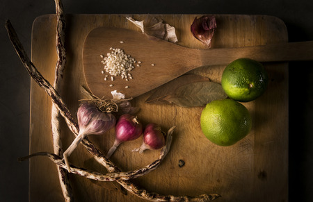 Lemons, garlics, sesame, beans on wood cropping block. Asia food spices and herbsの写真素材