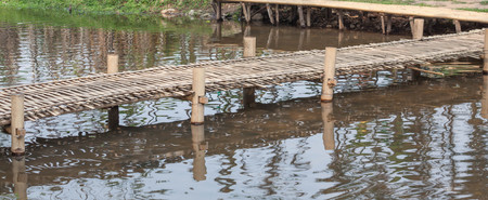 Little bamboo bridge over riverの写真素材