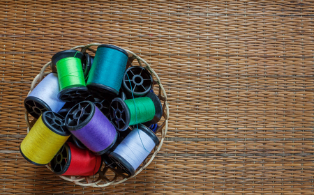 color thread on little plastic basketの写真素材