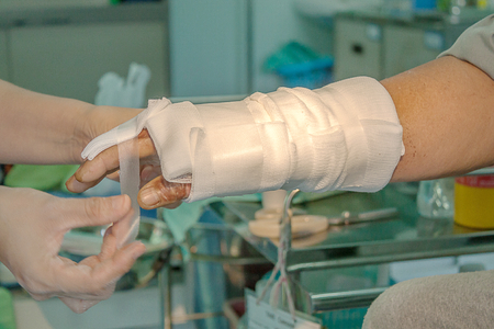 Dressing burned wound hand with gauze pad