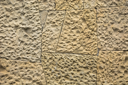 Background shot. A wall made of stones of various shapes and sizes.の写真素材