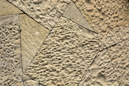 Background shot. A wall made of stones of various shapes and sizes.の写真素材