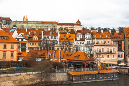 Prague / Czech - January 2 2018: Panorama of the city of Prague. The old part of the city. Beautiful roofs of shingles. Ancient buildings and churches. The stone embankment of the Vistula River.のeditorial素材