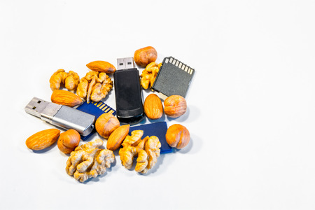 Composition of nuts and memory cards. Symbolizes the useful properties of nuts to improve human...