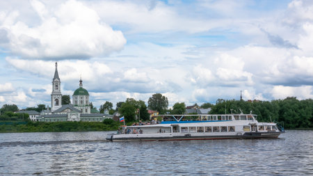 Tver / Russia - July 19 2020: City embankment of the Volga river in the amusement park. In the background there is an Orthodox church. Summer. Lots of green trees.のeditorial素材
