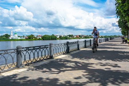 Tver / Russia - July 19 2020: City embankment of the Volga river in the amusement park. In the background there is an Orthodox church. Summer. Lots of green trees.のeditorial素材