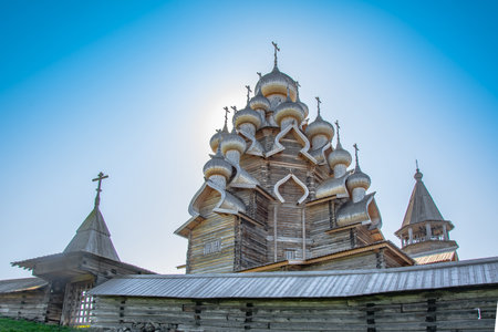 Historical, architectural and ethnographic open-air museum-reserve Kizhi. A view from afar on a wooden church, a bell tower on an island in Lake Onega. On the left is a wooden house with a haystack.のeditorial素材