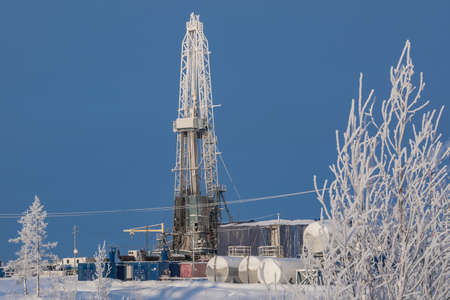 Winter landscape of a taiga forest with a drilling rig at the Northern oil and gas field. Everything...